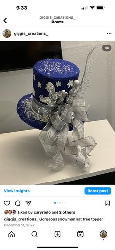 an image of a blue hat with silver bows on the front and back of it