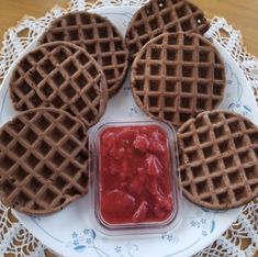 four waffles on a plate with ketchup