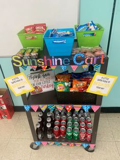 an assortment of sodas and snacks on a cart