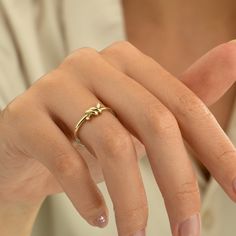 a woman's hand with a gold ring on it