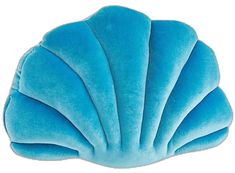 a blue scallop shaped pillow sitting on top of a white surface