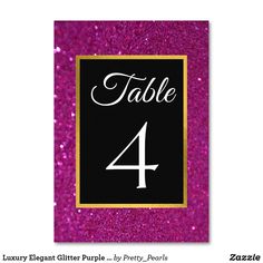 a table number card with the number four on it in black and pink glitters