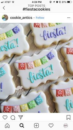 some cookies that are on a table with the words fiesta written in different colors and designs