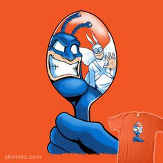 an orange t - shirt with the image of a cartoon character in front of it