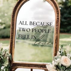 a mirror that has some flowers in front of it with the words all because two people fell in love