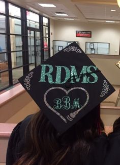 a graduate's cap with the words rdms on it in front of a class room