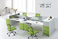 an office desk with green and white chairs