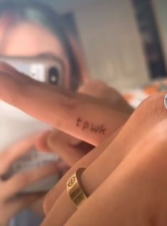 a woman pointing at her finger with the word twp written on it in cursive writing