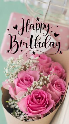 a bouquet of pink roses in a box with the words happy birthday written on it