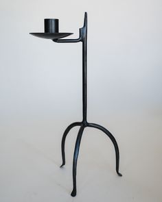 a black candle holder with a hat on it