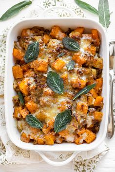 a casserole dish with butternut squash and sage