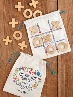 wooden tic - tac - toe game set and drawstring bag on a table