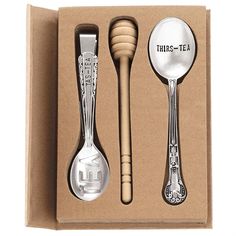 three spoons and two forks in a box with the words tinks - tea written on them