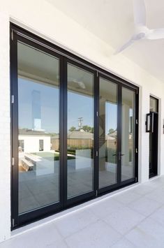 an empty room with sliding glass doors on the outside