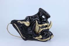 a black mask with gold details on it