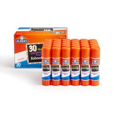 eight bottles of orange deodorant are next to an orange box with the same product in it