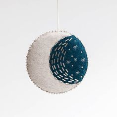 a blue and white ornament hanging from a string