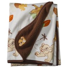 the baby blanket is brown and white with animals on it