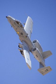 a fighter jet flying in the air with it's landing gear down and its engine out