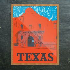 an orange and blue poster with the word texas on it is hanging on a wooden wall