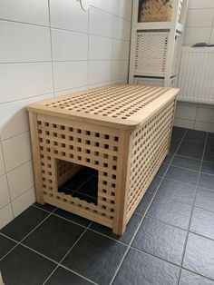 a wooden crate sitting on top of a tiled floor