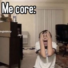 a young man is screaming while sitting in front of a computer desk with the words me core on it