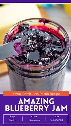 a jar filled with blueberry jam on top of a table