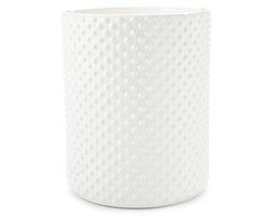 a white vase sitting on top of a table