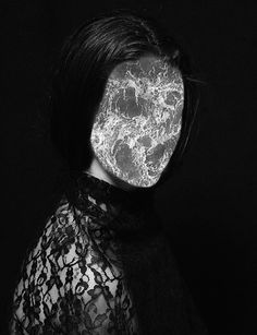 a black and white photo of a woman's face with the moon in her eyes