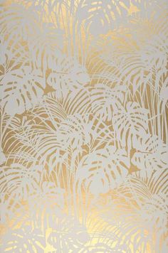 a gold and white wallpaper with palm leaves on the bottom right hand corner in front of it