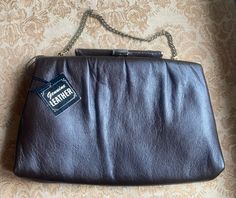 This stunning 1950's Andé evening bag still has it tag attached and intact! In great vintage condition- expected wear on corners, a couple tiny indents and very small tear in the leather on top of the latch (circled, see last two photos.) No damage to interior lining. Latch still works as intended; just press firmly against the side where the chain handle is attached to unlatch and open the bag. Bag measures 9 1/4 by 6 1/2 inches. ~ About my vintage bags and wallets: since preferences vary by pe Structured Bag, Vintage Purses, Wakefield, Bag Bag, Vintage Bags, Clutch Handbag, Vintage Tags, Evening Bags, Purses And Handbags