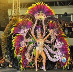 a woman in a costume is dancing on stage