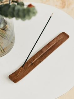 a white table with a wooden stick on it