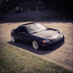 a black sports car parked in a parking lot