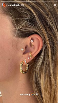 a woman's ear is shown with two small flowers on it