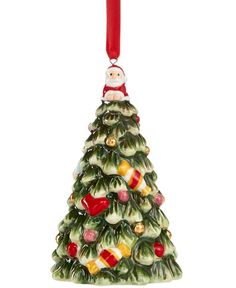 a ceramic christmas tree ornament hanging from a red ribbon