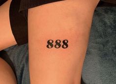 a woman with a tattoo on her leg that reads 808 and has the number eight in it