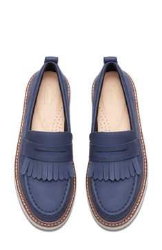 A sporty wedge modernizes a penny loafer complete with kiltie fringe. Cushioned footbed with arch support Leather upper and lining/rubber sole Imported Navy Leather Loafers With Textured Sole, Slip-on Platform Loafers With Rubber Sole In Calf Leather, Blue Slip-on Loafers With Rubber Sole, Navy Suede Slip-on Loafers, Navy Slip-on Loafers With Stitched Sole, Arch Support Shoes, Loafer Women, A Penny, Penny Loafer