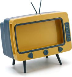 an old yellow television with black legs on a white background and no people around it