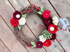 a wreath made out of flowers on top of a wooden table