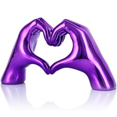 a purple heart shaped object sitting on top of a white surface