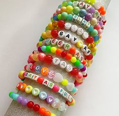 a stack of bracelets that say happy birthday and are decorated with beads on them