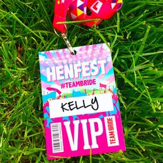 a pink badge with the word henfest on it next to a pair of headphones