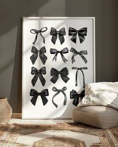 black bows are hanging on the wall in front of a white framed art print,