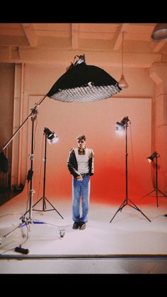 a man is standing in front of several lights