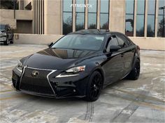 a black car parked in front of a building