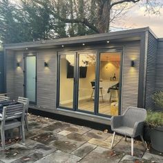 a garden room with sliding glass doors and patio furniture