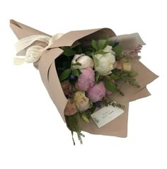 a bouquet of flowers is wrapped in brown paper and tied with a white ribbon on top