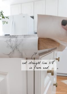 a kitchen counter with a roll of paper on it and the words cut straight line 1 / 8'in from end