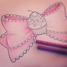 a drawing of a cupcake with a bow on it and two crayons next to it